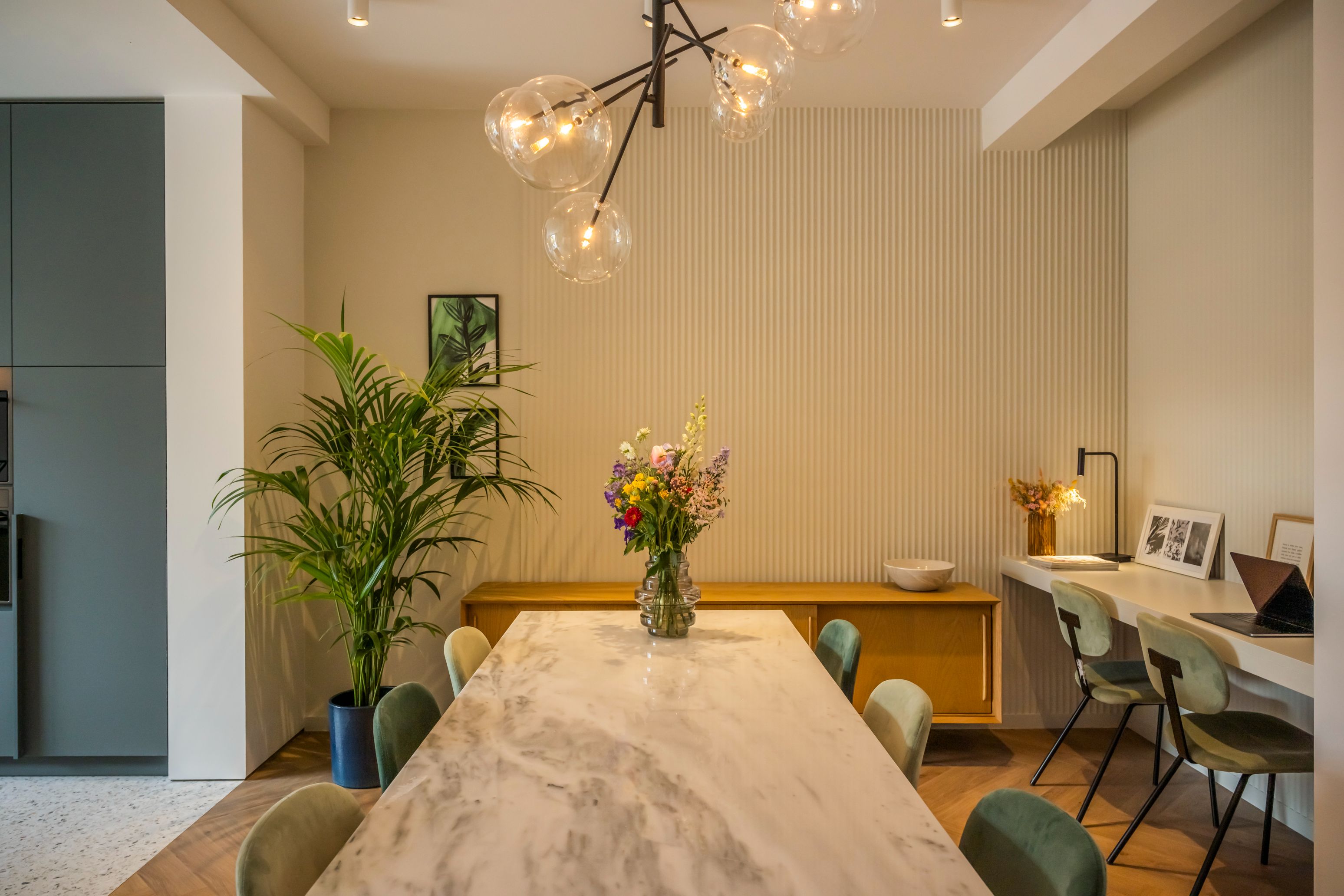 modern and warmly lit combined dining room with office space and beige walls sundae house credit website image